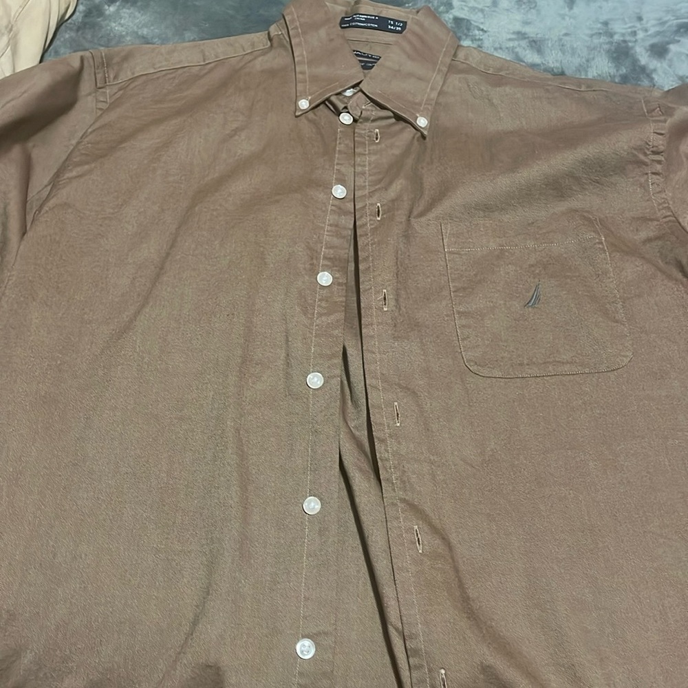 Nautica dress shirt brown in color with a grey boat